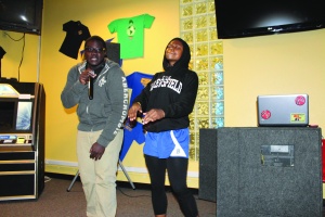 Michael Ogundare, a junior, sang a Boys II Men song along with the help of Erica Hawkins, a senior, at the Poetry Slam/Open Mic Night at The Roost on Feb. 20. (Lexi Philippi/ The Runner) 