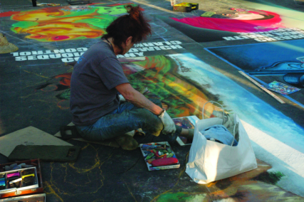Photos by Tara Baraceros/The Runner Artists work to finish their chalk and pastel art pieces at 