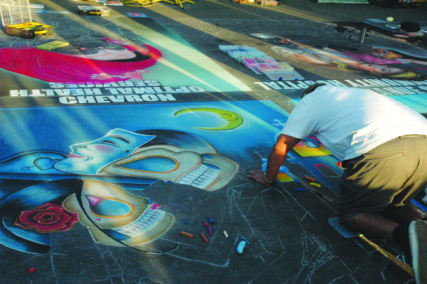 Photos by Tara Baraceros/The Runner Artists work to finish their chalk and pastel art pieces at  