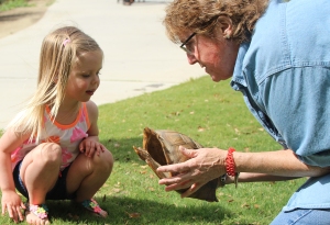 Terri Hayes, a CALM employee, teaches a little girl about the life cycle of a tortoise during the park’s spring fling event on Apr. 18, 2014.