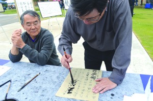 Marisel Maldonado/The Runner Jiafan Lin, MD, Pathologist at Memorial Hospital, had a Chinese calligraphy booth at the Celebrate CSUB event on April 26. Chinese calligraphy is a personal hobby of his.
