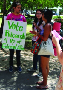 Crismat Mateo/The Runner Ricardo Perez, vice president of external affairs, walks around campus with posters and talks to his schoolmates to encourage them to vote for him on Thursday, May 15.