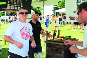 Layne Ogle/The Runner Chris Vaughn (right), co-founder of Barrel House Brewing Company, enjoys volunteering at the Craft Beer Festival on Saturday, May 24.
