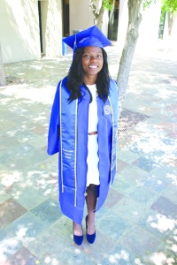 Bre Williams/The Runner Erica Hawkins, a 23-year-old graduate with a double major in criminal justice and religious studies, posed in her cap and gown outside Walter Stiern Library on May 28.